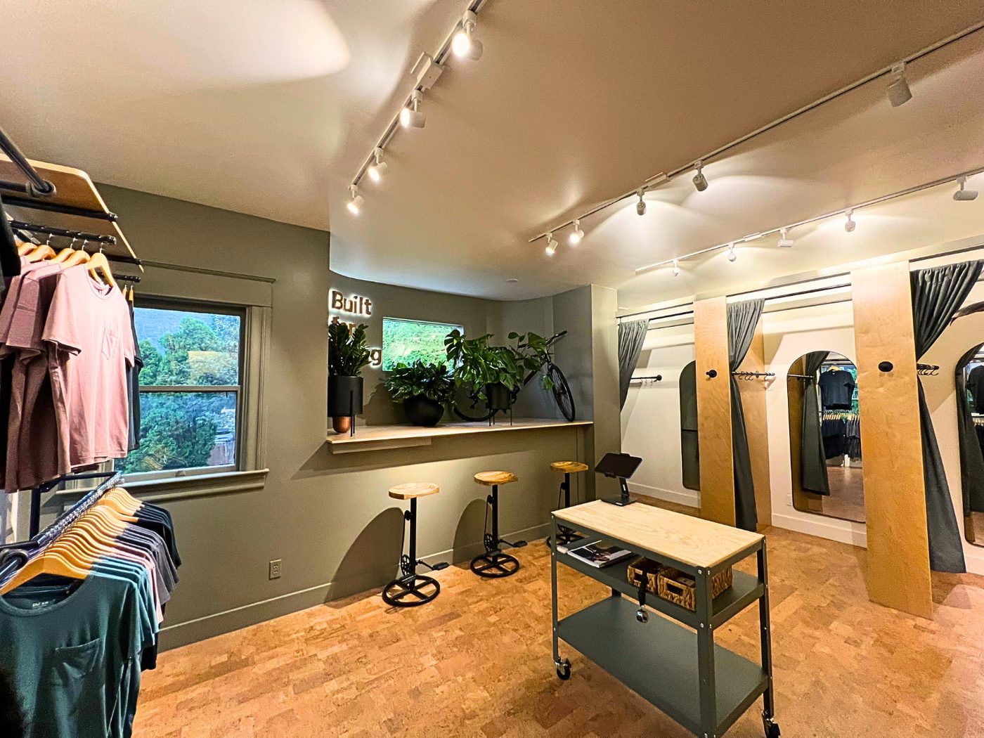 Retail space renovation — green walls, bar counter, fitting rooms — Stoneridge Projects